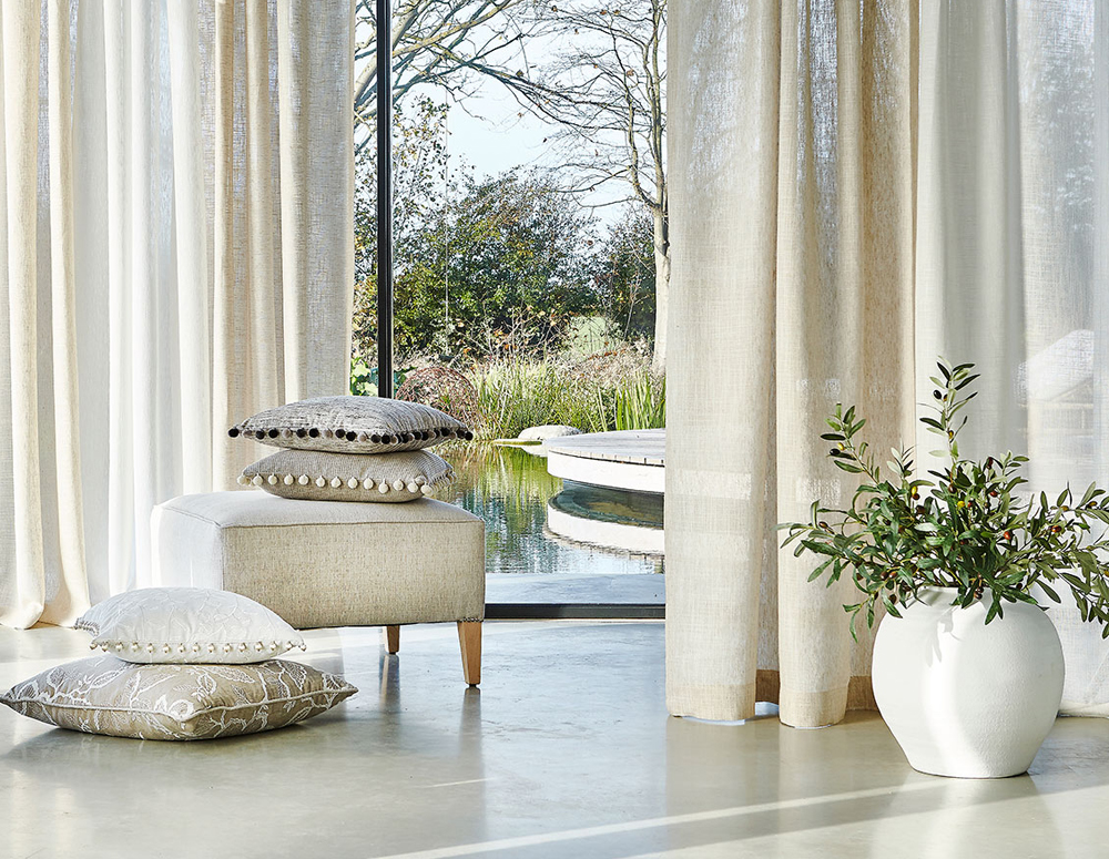 Cushions arranged in the open space of a home, styled and directed by SW Design Group Ltd.